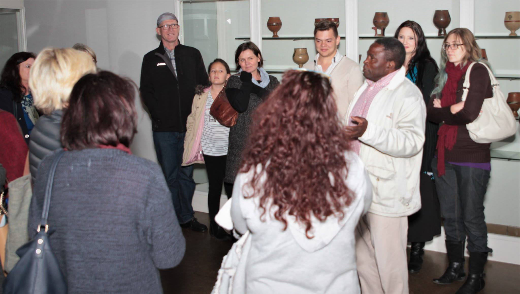photo of Lorette behind the podium speaking on Art Therapy